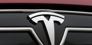Tesla profits slump by more than a half