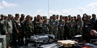 China’s military unveils robot dogs armed with rifles.